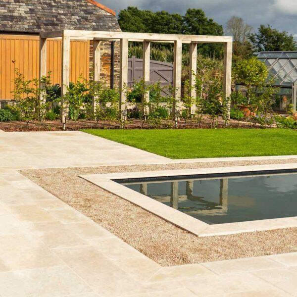Bampton aged limestone paving and matching pool coping