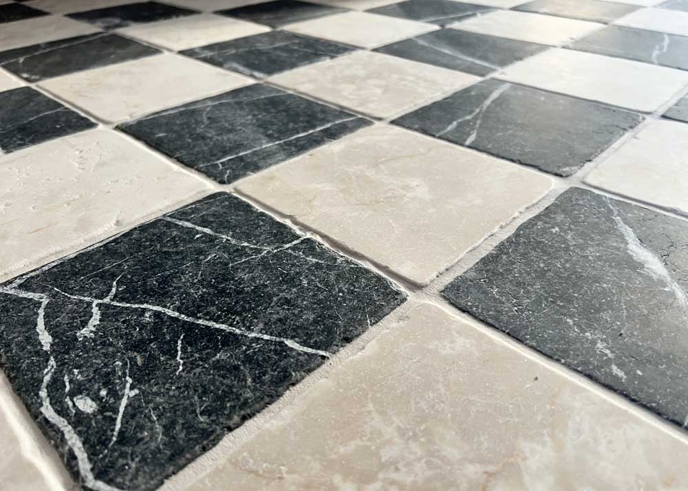 Black and cream tumbled marble floor tiles checkerboard